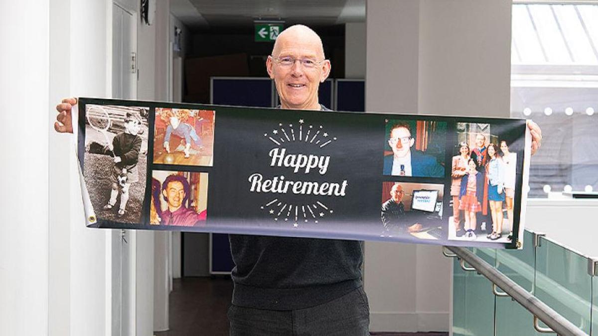 A photo of Porteous holding happy retirement banner