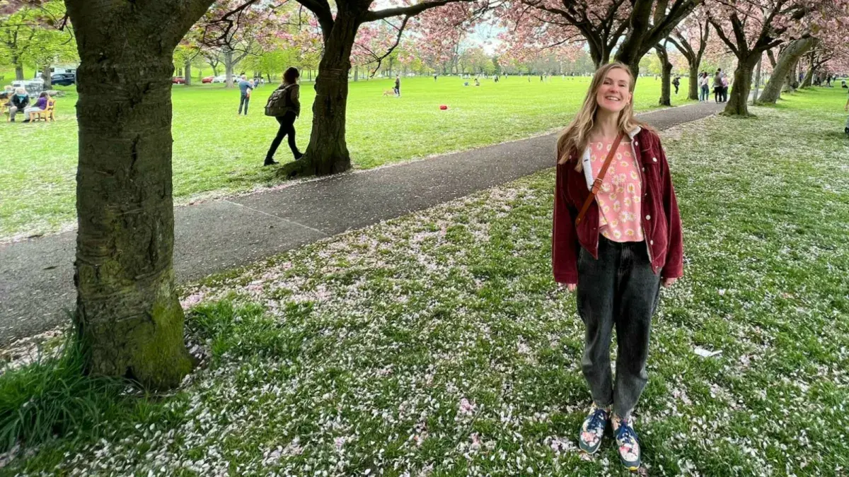 Kitty Sherwood in the meadows by cherry trees in blossum