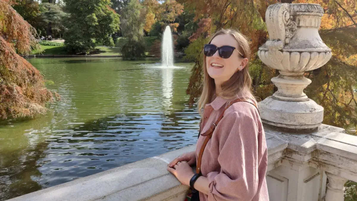 Kitty Sherwood in a park by a fountain