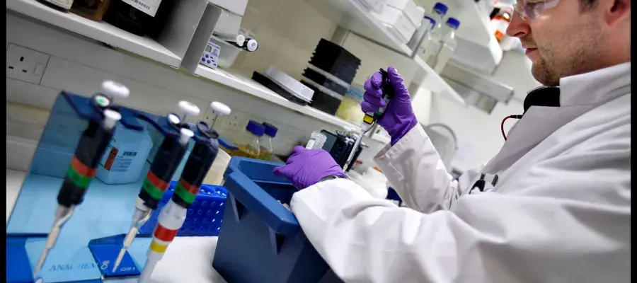 Student with pipette at lab bench