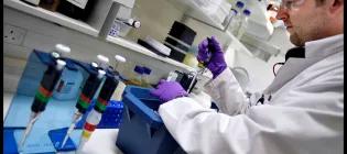 Student with pipette at lab bench