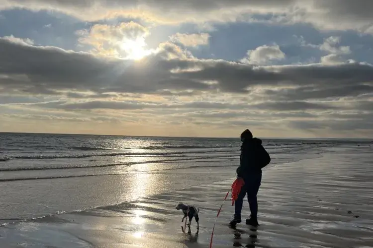 Hannah Smith and dog on the beach