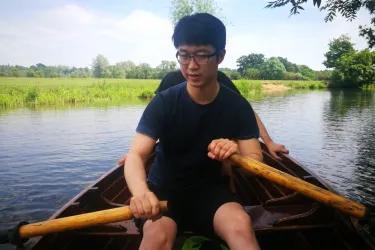 Mosi rowing a boat on a river