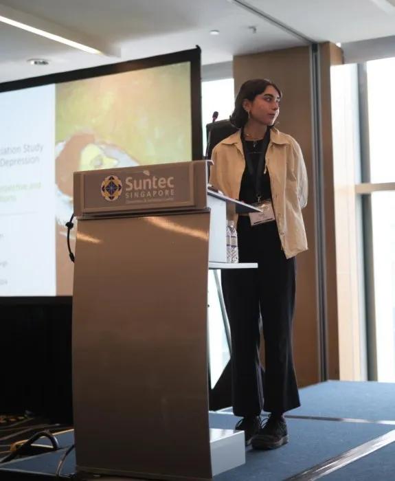 Poppy presenting at the World Congress of Psychiatric Genetics Singapore 2024