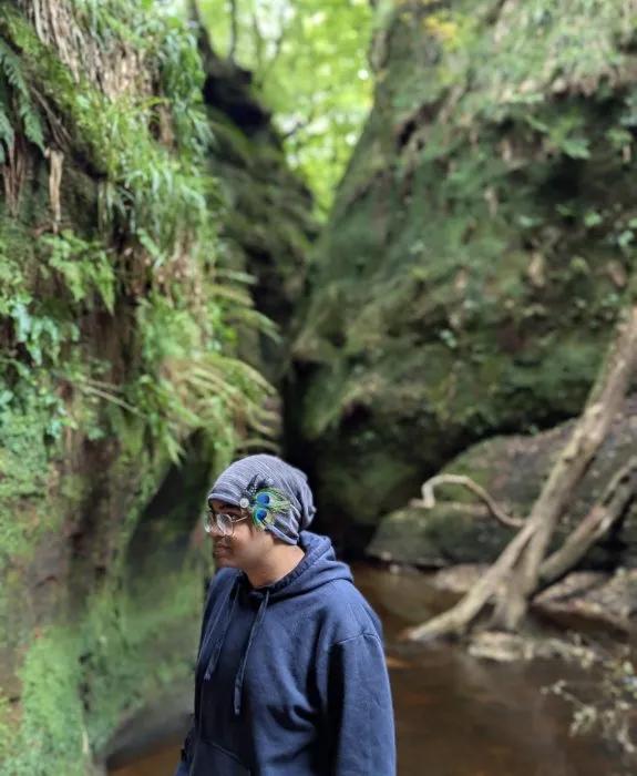 Tanmay Debnath in a valley by a river