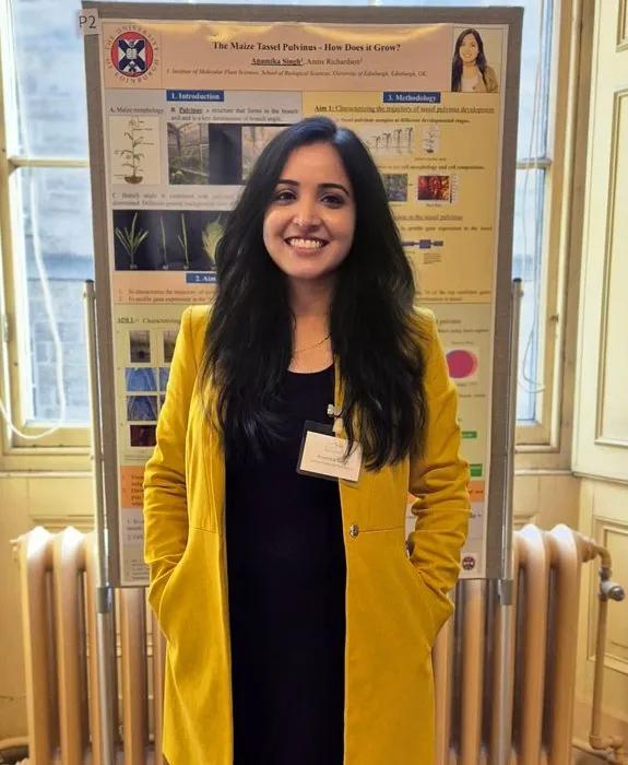 Anamika in front of an academic poster